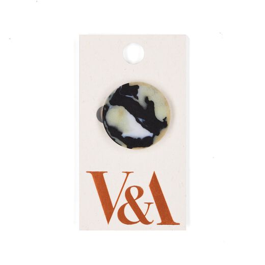 Black and white recycled fabric brooch with V&A logo
